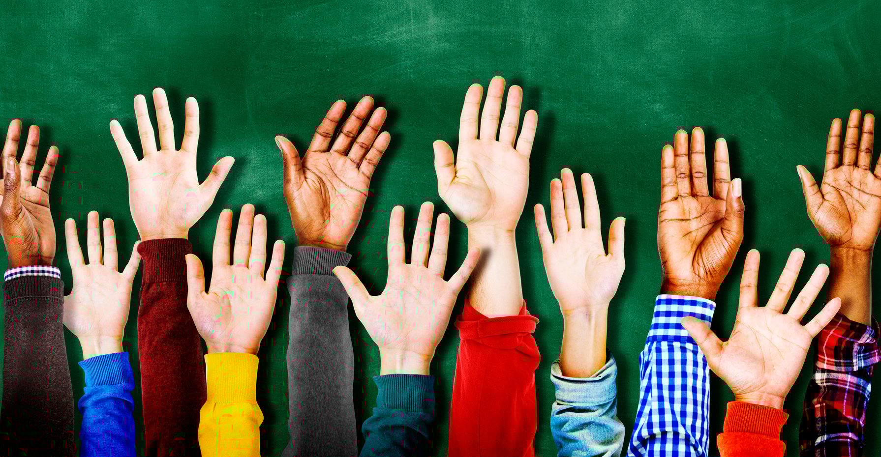 a group of people with their hands up in the air
